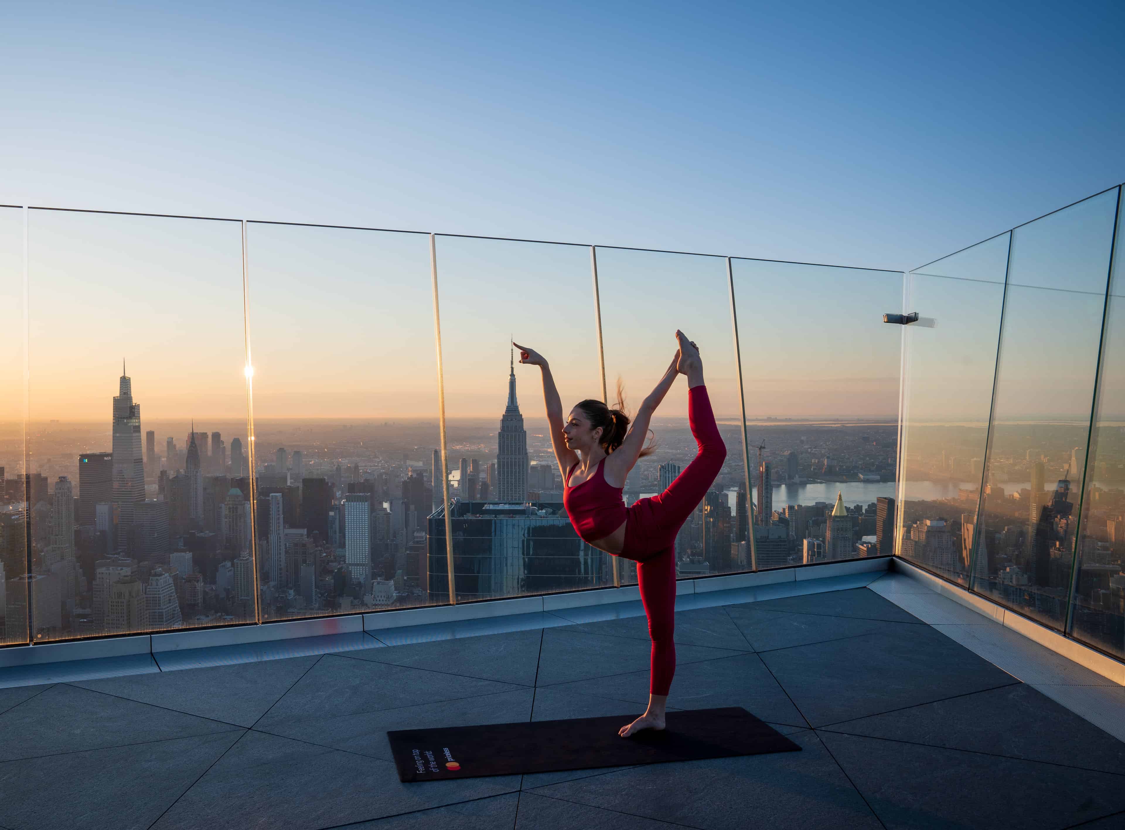 Woman doing yoga on sky deck