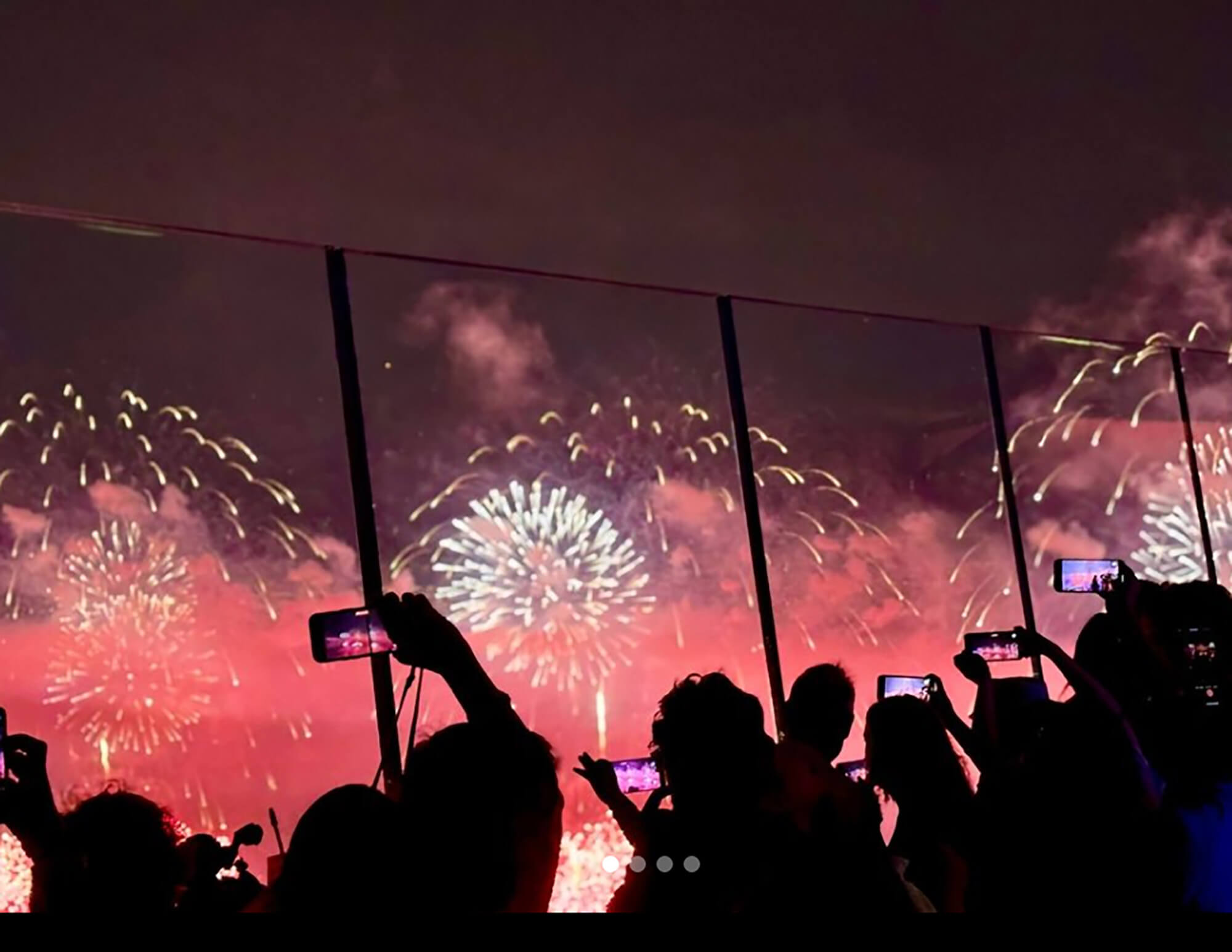 People take pictures of fireworks from The Edge