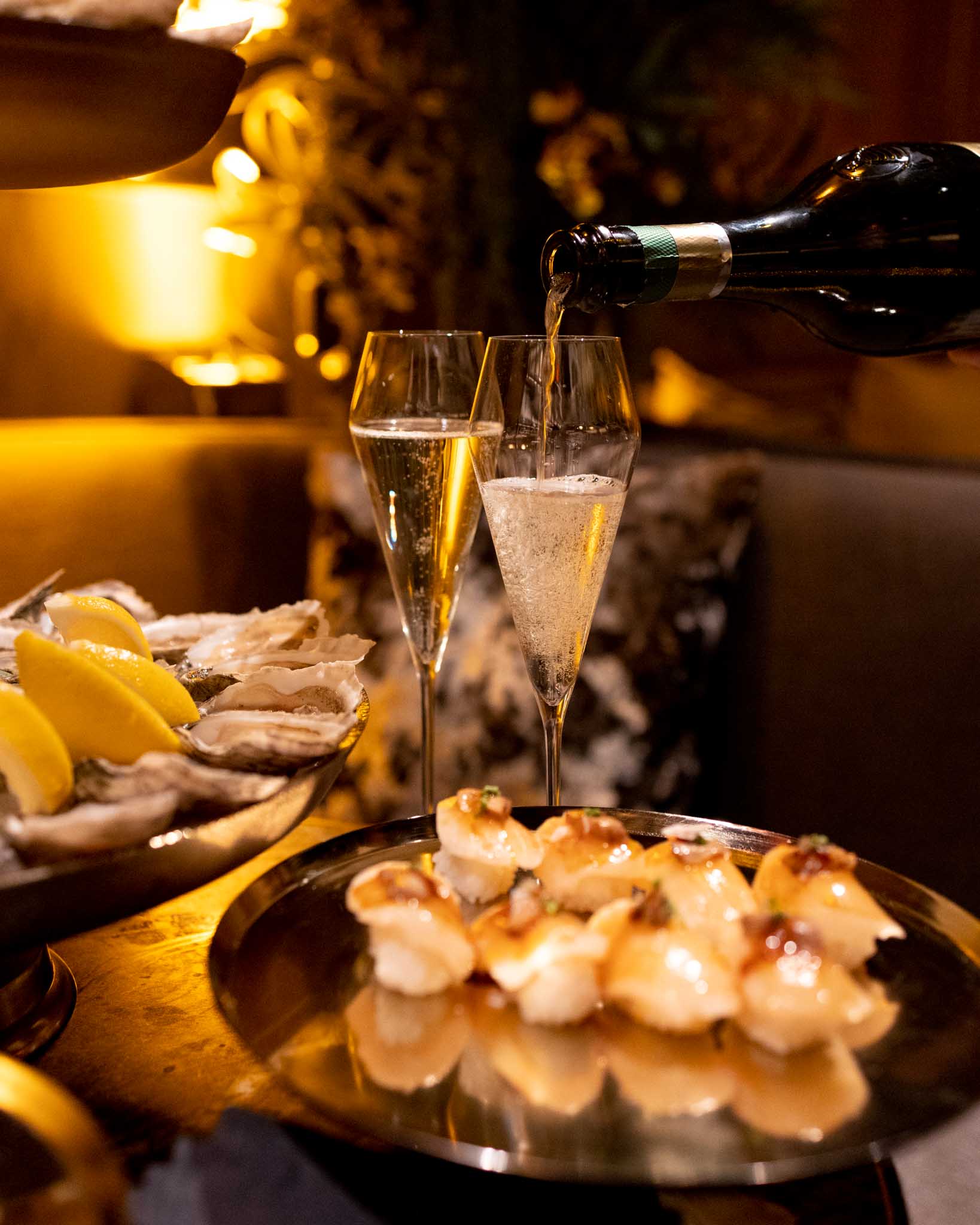 A plate of hors d'oeuvres, oysters and champagne