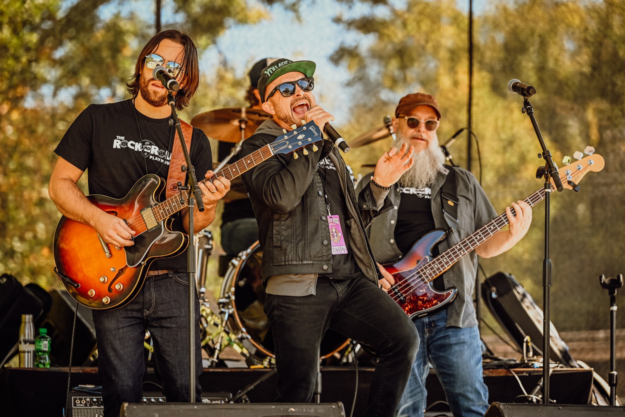 Rock and Roll Playhouse musicians on stage, playing to a crowd