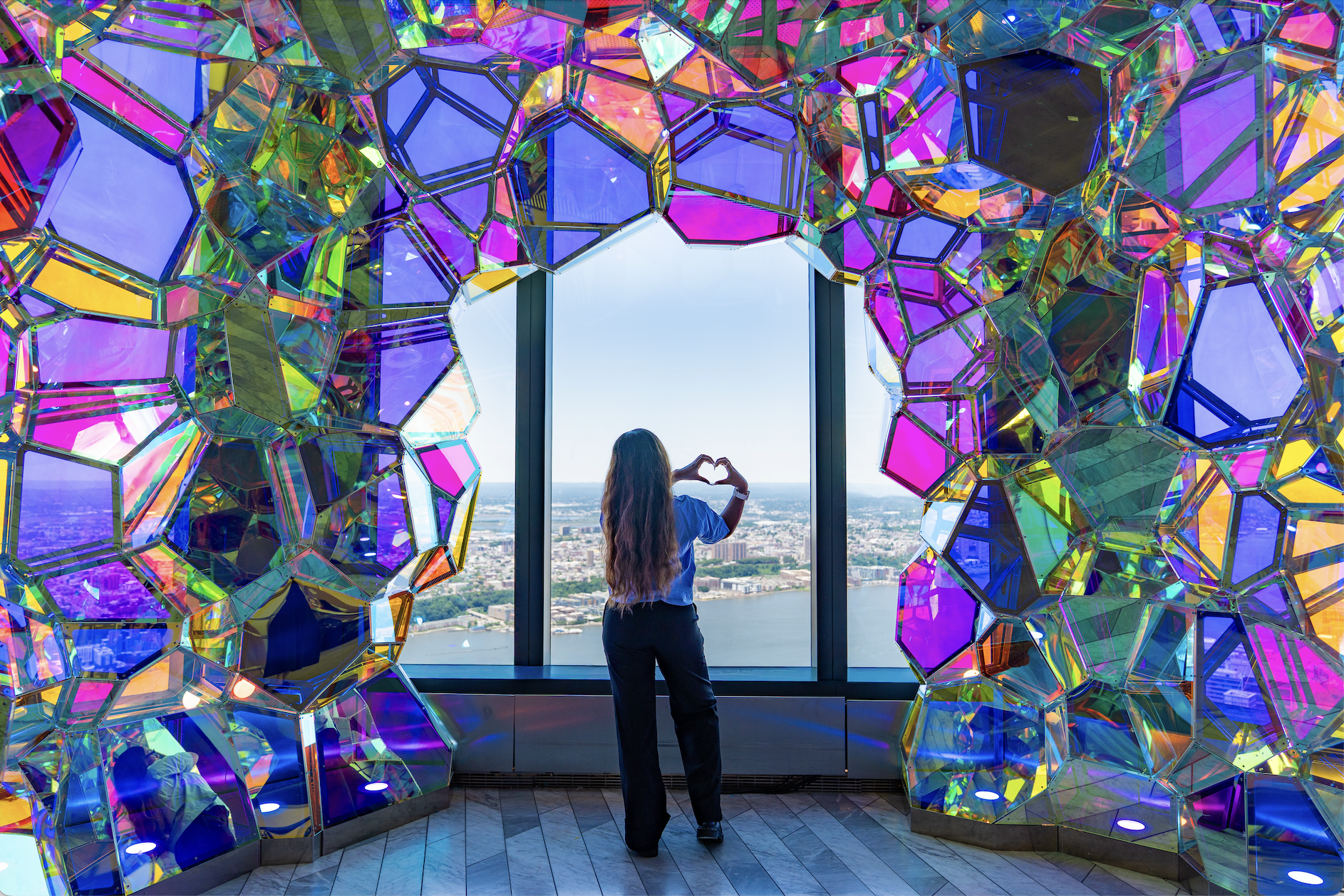 Group of guests moving through immersive installations at Edge NYC before stepping onto the outdoor sky deck
