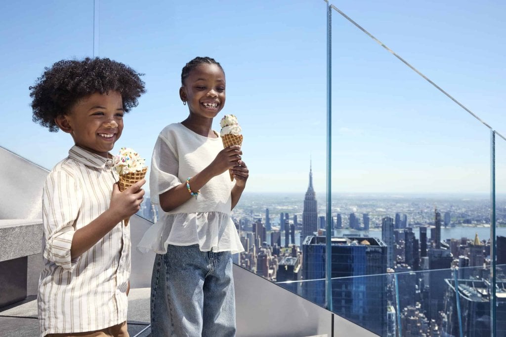23_KIDS_ICE_CREAM_2751-scaledjpg - Edge NYC - Edge NYC Two children enjoying ice cream with NYC skyline and Empire State Building in background.